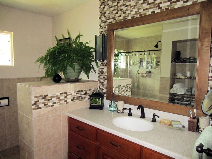 remodeling our 1970 s bathroom, bathroom ideas, home decor, home improvement, We found a deal on the cherry vanity that suited our casual rustic style which was a sample made by a local cabinet maker the mirror was found at a garage sale and the lights came from Habitat for Humanity