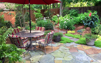 A few photos of a recent installation.  No more grass, but a nice stone patio, hot tub, and new plantings.