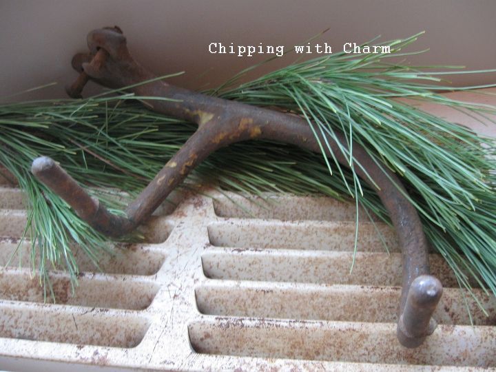 quirky rusty antler winter centerpiece, seasonal holiday decor, Layered on a crusty vent with greens