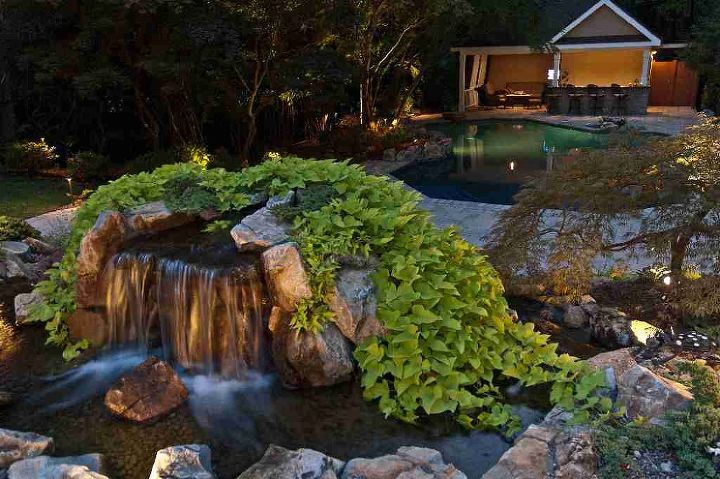 award winning backyard retreat includes portable spa, outdoor living, pool designs, spas, Retaining Wall Waterfall is part of natural looking retaining wall moss rock boulders plantings a terrific way of cutting costs and increasing aesthetic value of graded property It was positioned to be enjoyed from house and spa