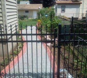 my large landscape project, flowers, gardening, landscape, I had an iron fence and gate installed so that people walking by my home can view the side yard