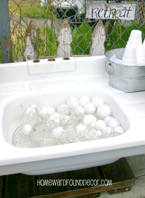i have a sink ing feeling about this project, flowers, gardening, outdoor living, repurposing upcycling, Vintage sink filled with dessert ware and plastic holiday ornament bubbles