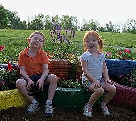 my flower tire garden, flowers, gardening, outdoor living, My two children sitting on the new tire garden