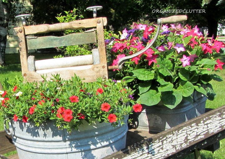 laundry themed chippy wheelbarrow, gardening, outdoor living, repurposing upcycling, The left tub is planted with red yellow and purple calibrachoa The small one with heliotrope and nicotiana