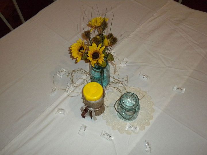 a casual homemade wedding, chalkboard paint, crafts, mason jars, Tablescape detail mason jars flowers tealights with vintage doilies twine and scattered mints burlap covered Wet Ones for wings buffet