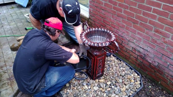 new water feature urn, outdoor living, ponds water features, The boys installing the hose