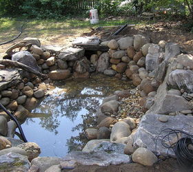 professional pond builders perspective on a backyard pond makeover in before during, outdoor living, ponds water features, Next we gravel all the points in between and around our boulders and rocks the gravel locks the boulders and rock into place as well as it serves as surface area for beneficial bacteria growth Great for aquatic planting too