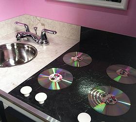 entertainment center turned play kitchen, diy, painted furniture, repurposing upcycling, The counter top is stick on faux marble floor tiles the sink was a mixing bowl and the faucet came from a remodeled bathroom The burners are CD s and white door pulls are the control knobs