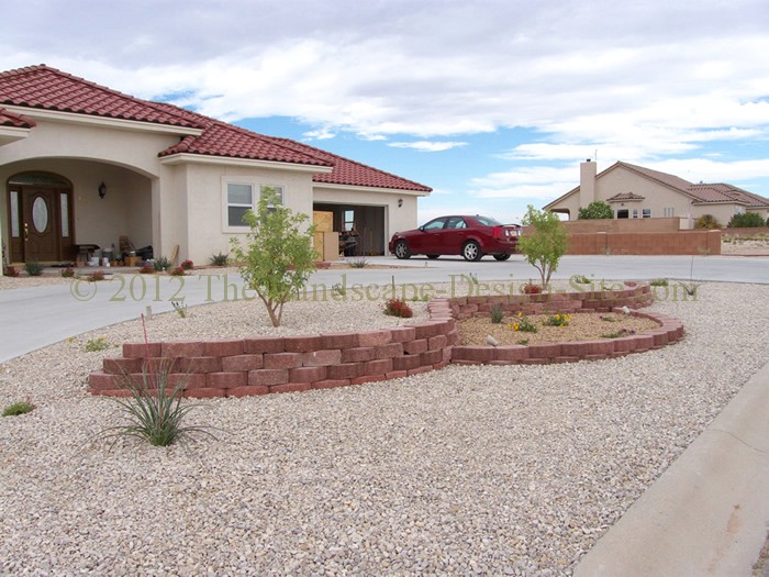 desert southwest landscaping on a small hillside circular driveway using retaining, Downhill side view of the two level retaining wall gives a better idea of how much slope there is on this circular driveway and front yard