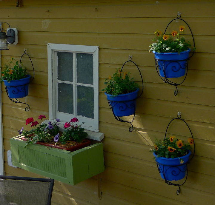 beginning to look like spring, Hangers on the shed with spray painted pots