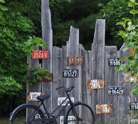 garden tour a landscape in vignettes, gardening, landscape, outdoor living, ponds water features, Repurposed license plates an old bike and a fence comprise one of the many vignettes in the garden