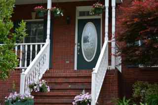 q help give this front porch some tlc, curb appeal, doors, porches, Our front porch is in need of some TLC The front door and shutters are painted green but years of sun and weather has caused the green to fade