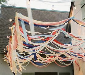 annual memorial day party prep, outdoor living, patriotic decor ideas, seasonal holiday decor, Cheap streamers from the dollar store mixed with some of my infinite mini light collection creates an eye catching accent when guest enter my entertaining area