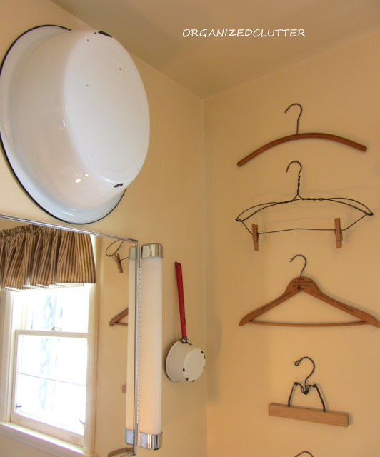 an organized clutter home tour, home decor, 3 4 bathroom with vintage hangers and enamelware