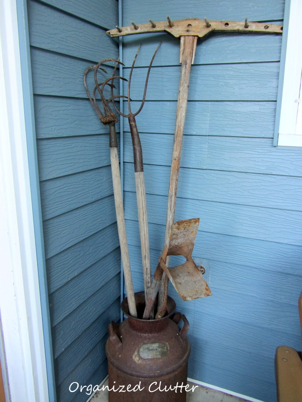 vintage garden farm tools are perfect for a junk garden, flowers, gardening, Put some long handled tools in a rusty milk can