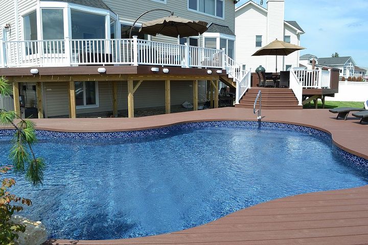 the deck and patio company replaces pool deck after hurricane sandy, curb appeal, decks, outdoor living, patio, Elegant Multi Level Deck and Freeform Pool In order to bring the outdoor space up to the same level as the home our design called for three deck levels leading from the door down to a new freeform vinyl pool