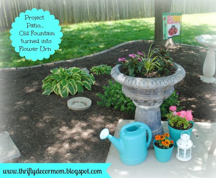 outdoor living space, outdoor living, Old broken fountain turned into flower urn Added aqua pots and watering can from Walmart to create this corner of the patio