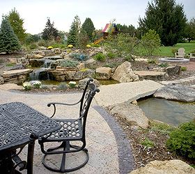 create a tropical dining spot in your backyard, decks, gardening, outdoor living, patio, ponds water features, A bridge invites you to explore more of this outdoor oasis before or after you eat