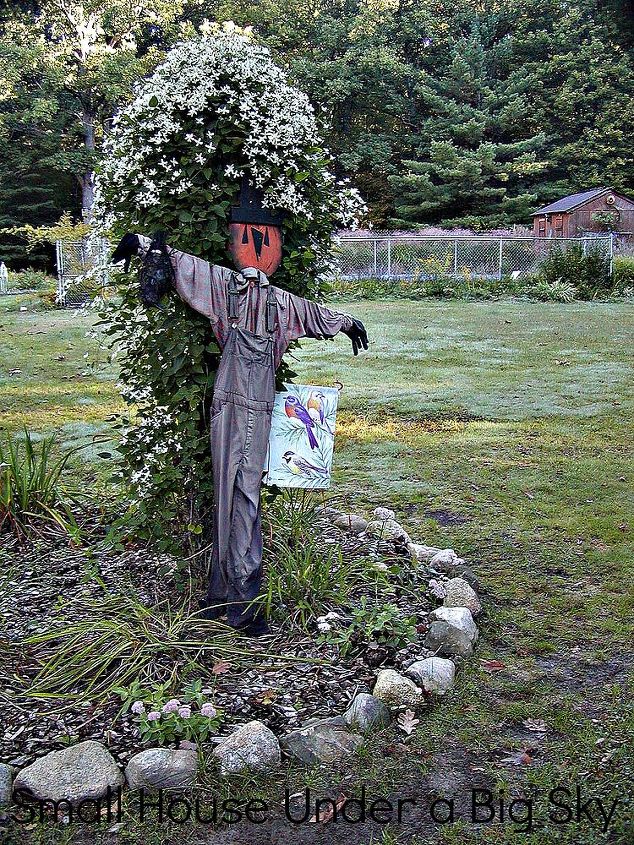 fall decorating at the small house under a big sky d cor roundup, flowers, gardening, seasonal holiday d cor, This scarecrow dressed in people clothing was made by a local artist and greets visitors who come to the Small House porch