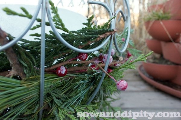 turn old hanging baskets into outdoor luminaires, electrical, repurposing upcycling, seasonal holiday decor, Line the bottom with greens and faux berries
