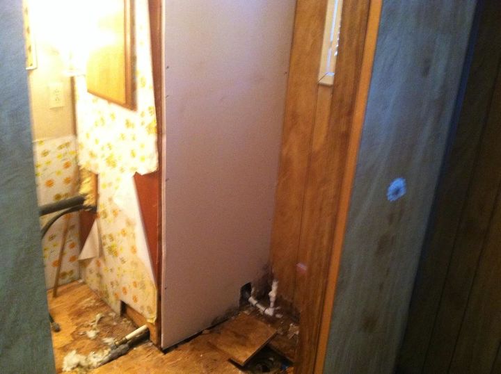 q i bought a handy man special and need a bit of help, diy, flooring, how to, woodworking projects, back bathroom on th right side is where the toilet goes The toilet drain sit below the floor How do I hook a toilet up like that is there a extension
