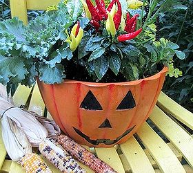 autumn in the garden, container gardening, garages, gardening, seasonal holiday decor, Autumn harvest chair in the garden made with Indian corn a 5 garage sale chair and a jack o lantern planter with solidago growing in the background