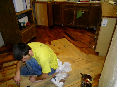 reclaimed barn wood kitchen floor, flooring, Putting on the first coat of polyurethane