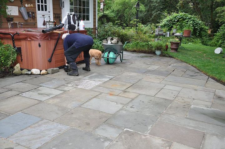 our pennsylvania bluestone patio gets a face lift, diy, patio, tiling, Mark working to clear off the patio