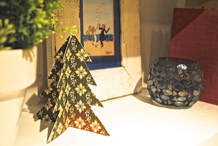 simple folded christmas trees, christmas decorations, seasonal holiday decor, These trees can be tucked along a mantel in windows in nooks on end tables as part of your holiday table I even thought they d make cute gift tags