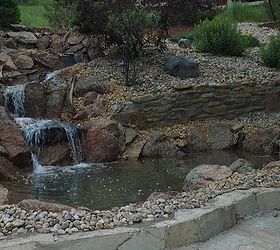 water features through walls, gardening, landscape, outdoor living, ponds water features, wall decor, The homeowners took an ordinary backyard with an extreme slope and turned it into a beautiful landscape with this pond and stream running through their retaining wall at Parker CO