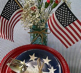 patriotic picnic bbq happy memorial day, outdoor living, patriotic decor ideas, seasonal holiday decor, Baby s Breath Carnations in a blue tinted mason jar with a few little flags make a quick patriotic centerpiece