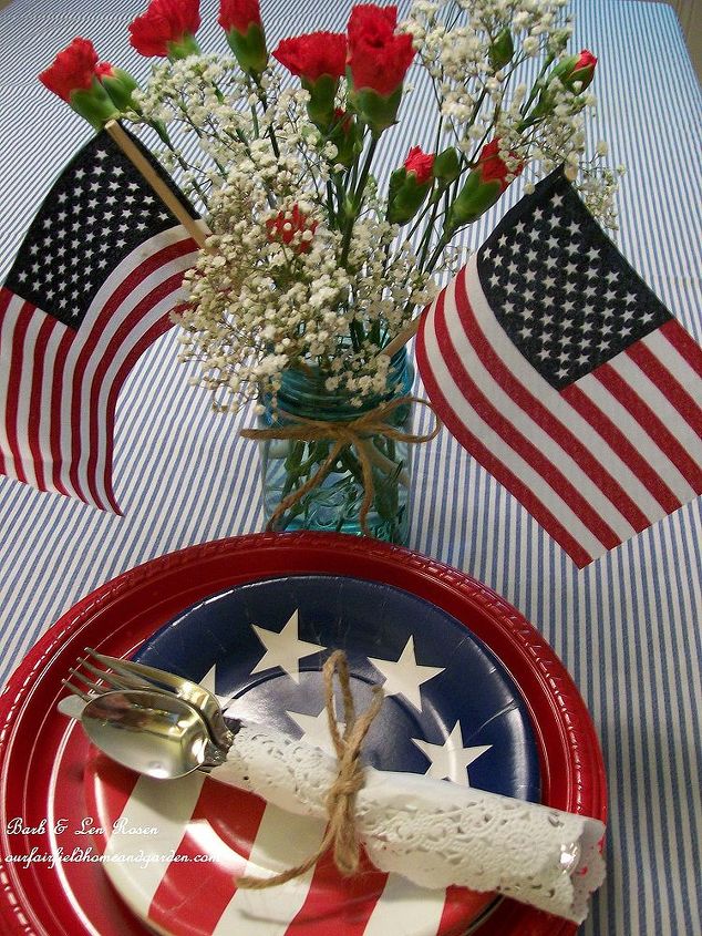 patriotic picnic bbq happy memorial day, outdoor living, patriotic decor ideas, seasonal holiday decor, Baby s Breath Carnations in a blue tinted mason jar with a few little flags make a quick patriotic centerpiece