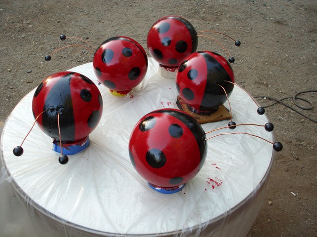 bowling balls to ladybugs, crafts, repurposing upcycling, cut 1 inch wooden plugs from a old broom handle then drill a small hole for the wire add wooden balls from the craft store glue them in the holes