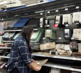 She grabs 2 placemats from Walmart for this genius lighting hack