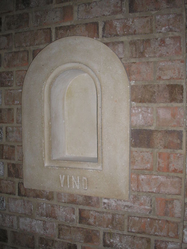 this niche is in a brick wall over the bar and next to the entry door of the wine, VINO wine bottle niche for Wine Cellar