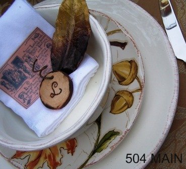 autumn tablescape, seasonal holiday decor, A custom napkin with a vintage label and a wood disc with each guests initials accent the dinnerware