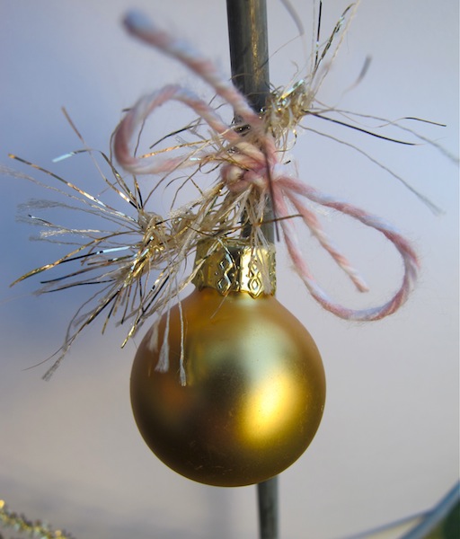 re purposing a tomato cage into a christmas tree, christmas decorations, repurposing upcycling, seasonal holiday decor, Tie on pretty decorations Secure with glue