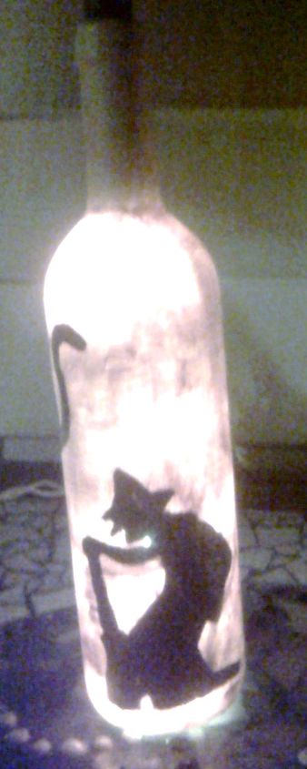 i upcycled empty wine bottles into halloween lamps, crafts, halloween decorations, seasonal holiday decor, Painted witch and cat on