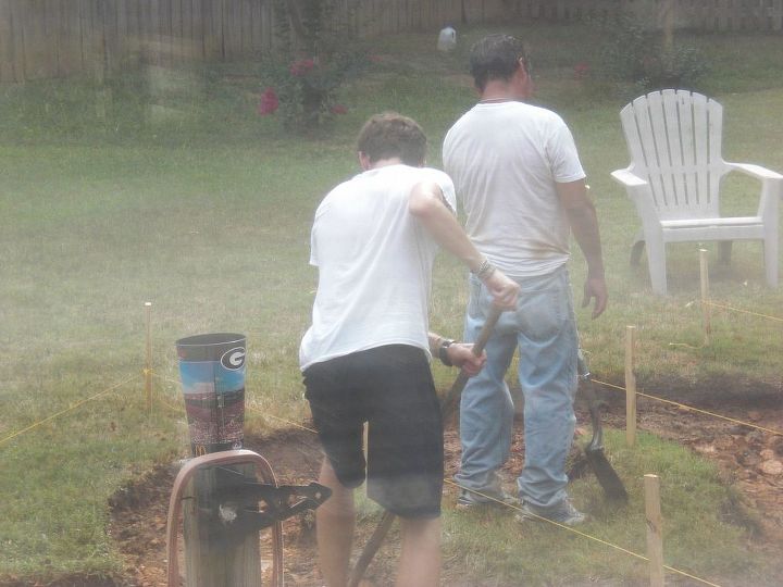 down home southern firepit, concrete masonry, diy, how to, outdoor living, Pouring rain but still digging