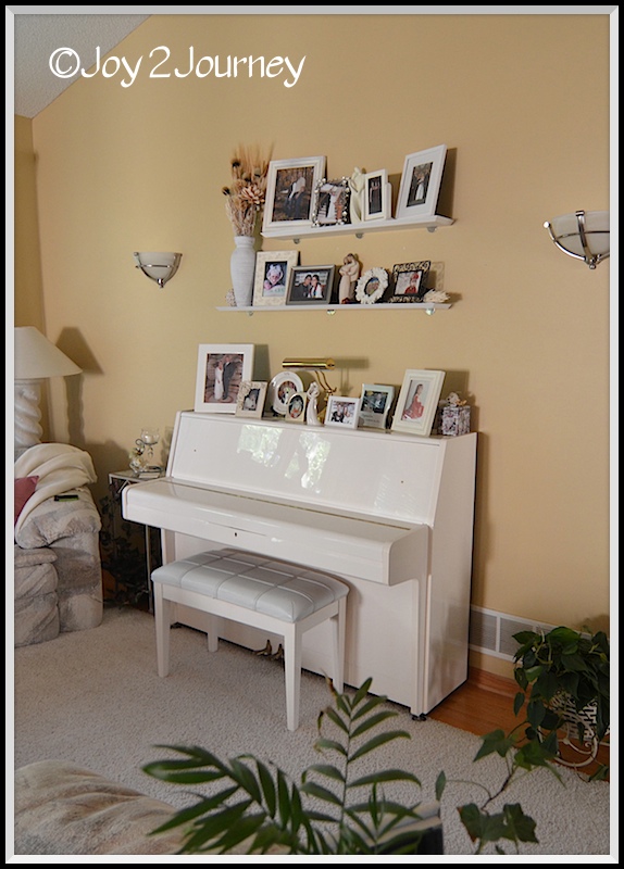 my living room retreat, home decor, living room ideas, painted furniture, Photos of family over a piano full of memories