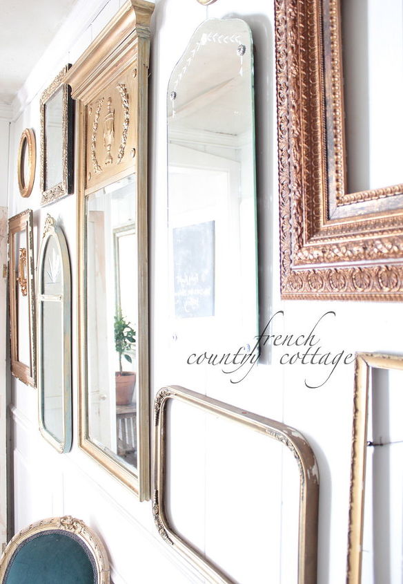 a gallery wall of vintage frames and mirrors, home decor