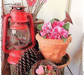 valentine s day porch, home decor, porches, seasonal holiday decor, valentines day ideas, I used a vintage red lantern and placed this rose kissing ball into this flower pot I placed pink flower bud branches into this rusty watering can and made a love nest