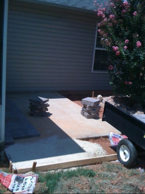 enlarging my patio, concrete masonry, diy, patio, After the form was made I mixed and poured two bages of concrete at a time
