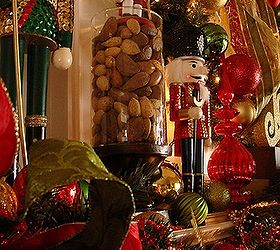 christmas on my mind, christmas decorations, fireplaces mantels, seasonal holiday decor, Traditional holiday nuts served as the perfect perch in a glass vase for our shorter nutcrackers to stand guard a little easier