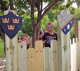 diy build your kids a play castle, diy, outdoor living, woodworking projects, We used fencing and varied the length to make it look like a castle The kids painted shields which were the finishing touches on their castle