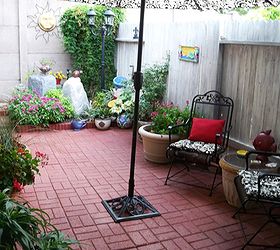 back yard patio makeover, outdoor living, Back patio with our smaller fountain in the flower bed