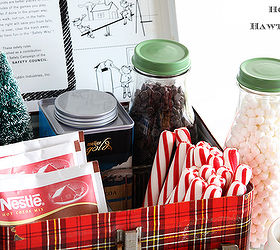 cozy hot cocoa station for the holidays, christmas decorations, seasonal holiday decor, Various hot cocoa packets candy cane sticks mini marshmallows and chocolate chips corralled in a vintage lunch box could use a tray or and empty Christmas cookie tin