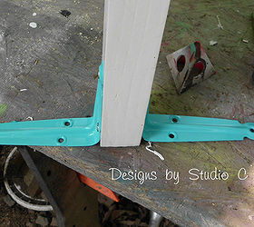 creating a house number sign with an old cabinet door, curb appeal, repurposing upcycling, Close up of the feet two spray painted shelf brackets on either side of the leg