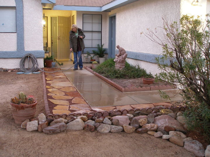 sand stone walk way, Added rocks and a broken cement fountain to the low end of the walkway to keep water from washing away the soil This is a typical desert landscape for Arizona
