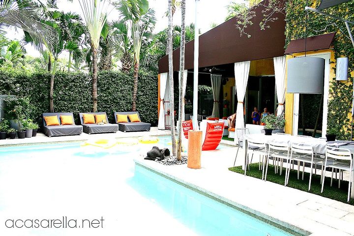 tropical industrial home tour, home decor, outdoor living, pool designs, The pool area is flanked with relaxing lounges